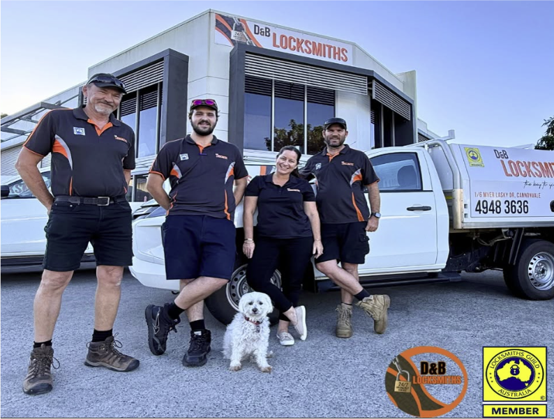 The D & B Locksmiths team and their dog outside the Cannonvale workshop beside the branded service ute